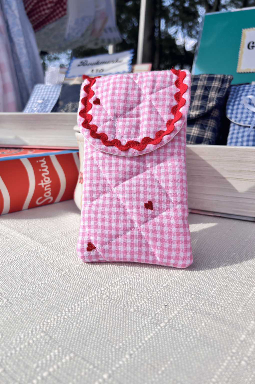 Handmade pink gingham quilted glasses case with embroidered red hearts and red rickrack trim perfect for valentines day or teachers day gift