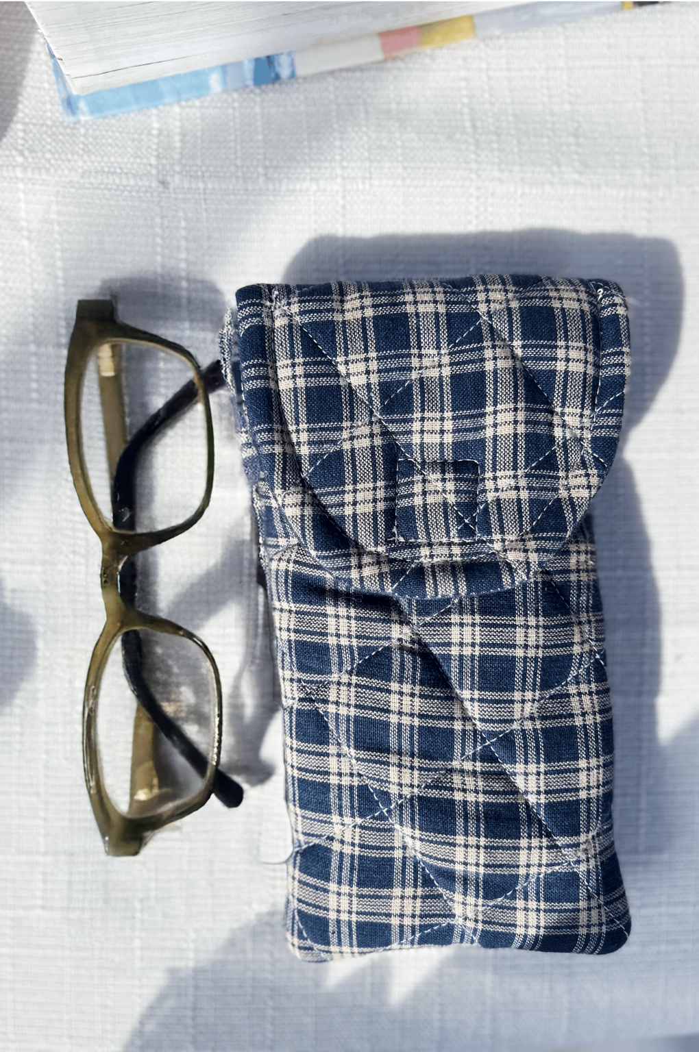 Handmade Navy plaid quilted glasses pouch with flap and Velcro closure, paired with a matching fabric bookmark. Cozy, handmade gift idea for him and readers